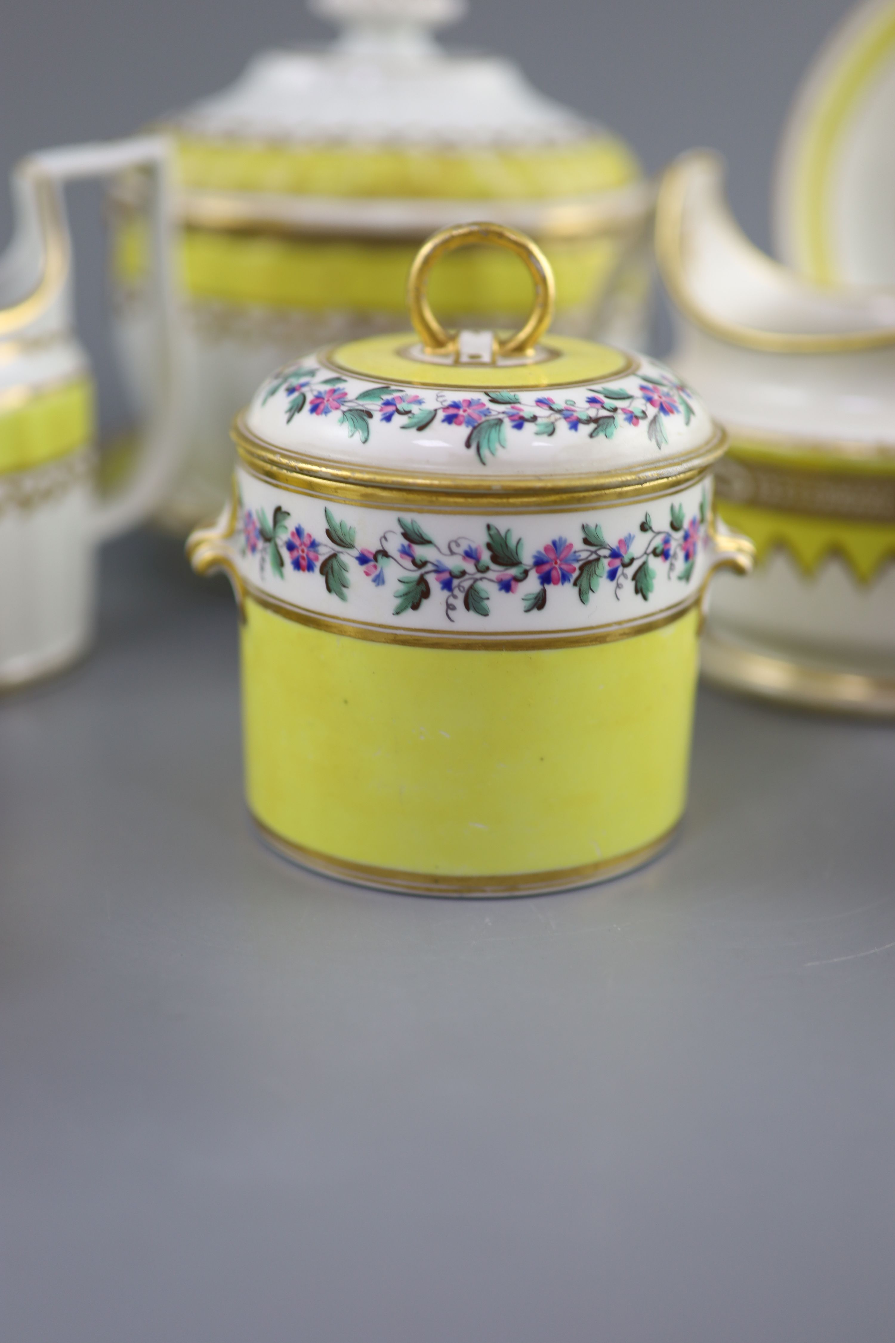 A group of Derby yellow ground tea and coffee wares and a chamberstick, c.1790-1800